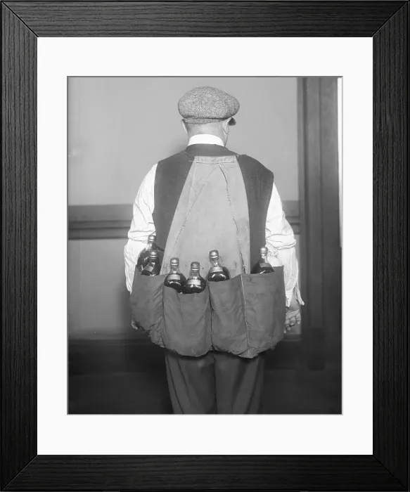 Framed Print : Man Wearing Coat Holding Bottles Framed Print : Man Wearing Coat Holding Bottles