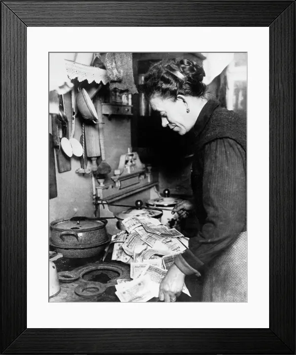 Framed Print : Woman Lighting Fire with German Money Framed Print : Woman Lighting Fire with German Money