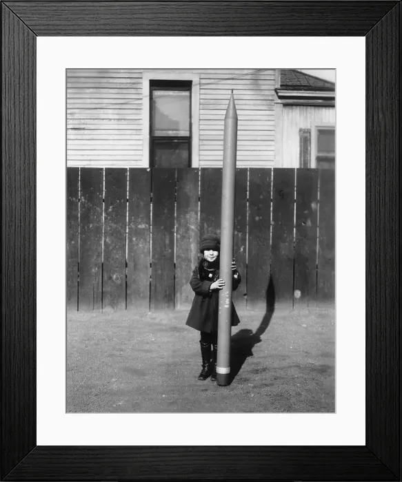 Framed Print : Schoolgirl (6-7) with large crayon Framed Print : Schoolgirl (6-7) with large crayon