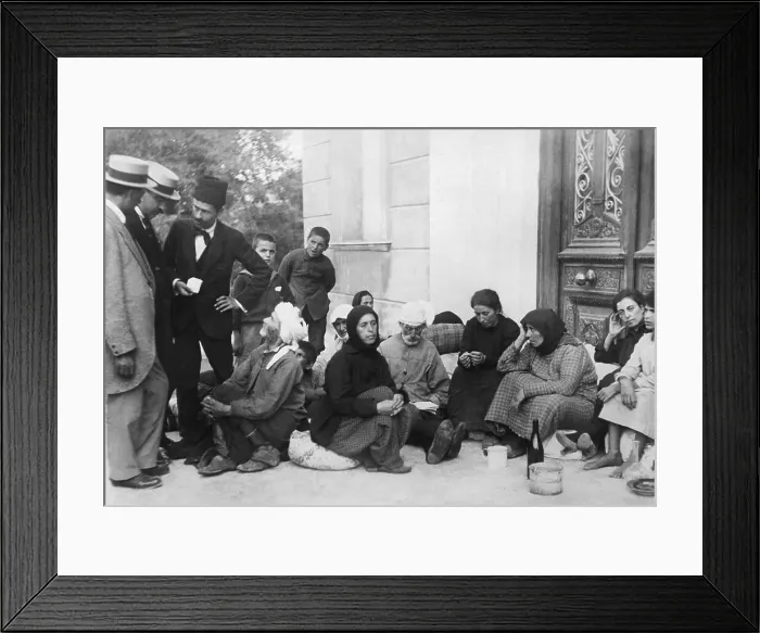 Framed Print : Group of Refugees Seated in Doorway