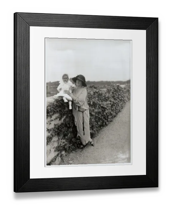 Framed Print : Socialite Woman Holding infant Framed Print : Socialite Woman Holding infant
