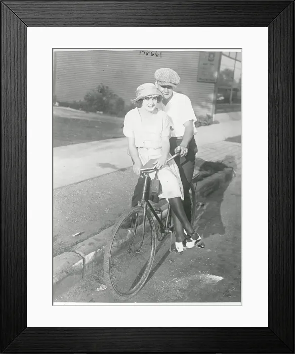 Framed Print : Couple Riding Bicycle During Car Strike Framed Print : Couple Riding Bicycle During Car Strike