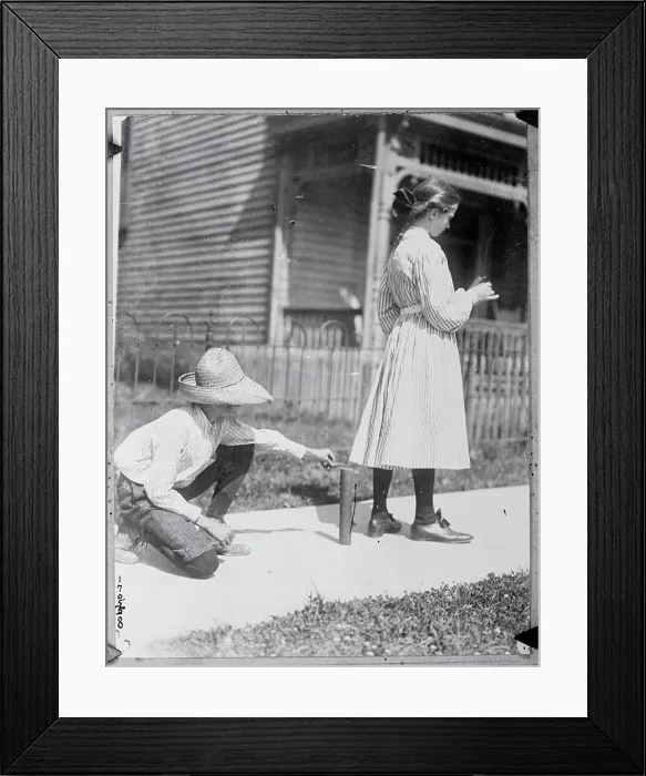 Framed Print : Boy Lighting Firecracker Behind Girl Framed Print : Boy Lighting Firecracker Behind Girl