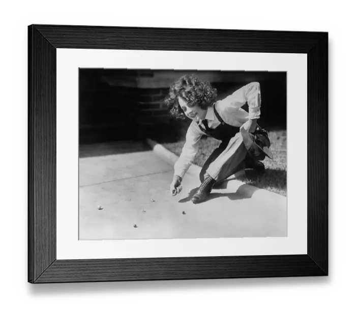 Framed Print : Teenage girl (13-15 years) playing marbles on pavement. Atlanta, Georgia, USA. April 11, 1922