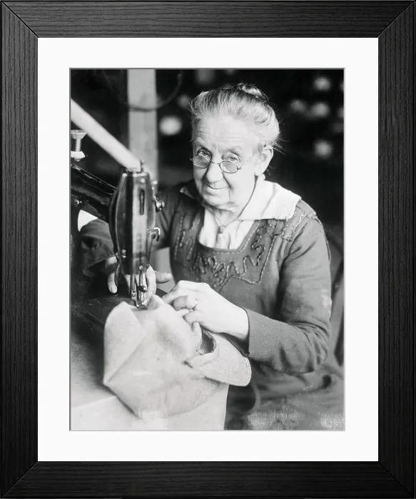 Framed Print : Woman Sewing a Cap Framed Print : Woman Sewing a Cap