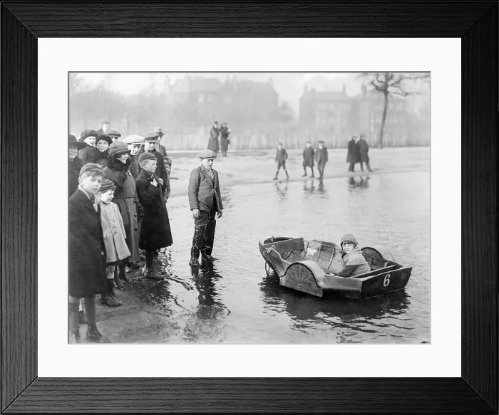 Framed Print : Girl (8-9 years) in propelled boat in park, Clapham Common, London, England, UK. March 31, 1922