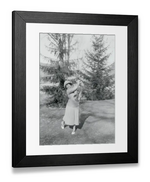 Framed Print : Woman Swinging a Golf Club Framed Print : Woman Swinging a Golf Club