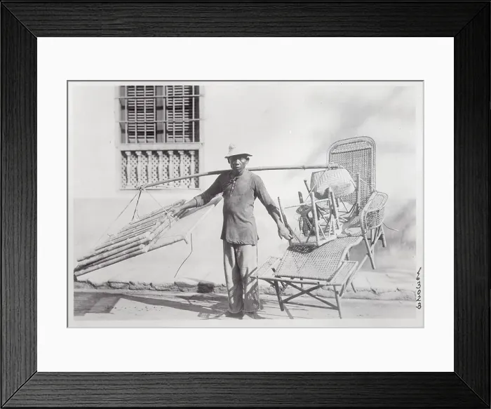 Framed Print : Man Saddled with Wicker Furniture Framed Print : Man Saddled with Wicker Furniture