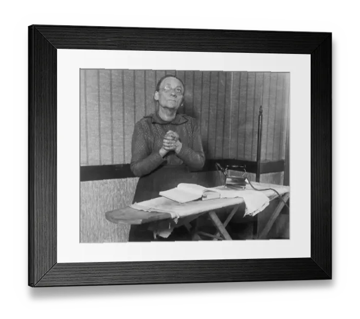 Framed Print : Elderly Woman Praying over Ironing Board Framed Print : Elderly Woman Praying over Ironing Board