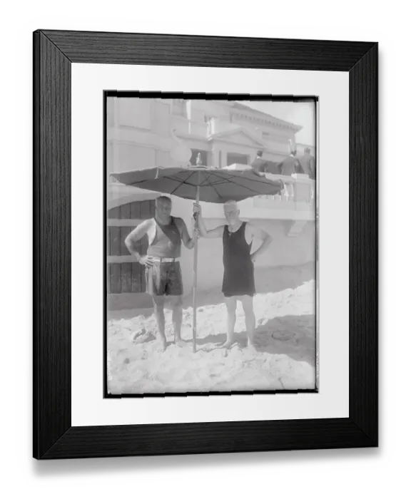 Framed Print : Two Men Holding a Beach Umbrella Framed Print : Two Men Holding a Beach Umbrella