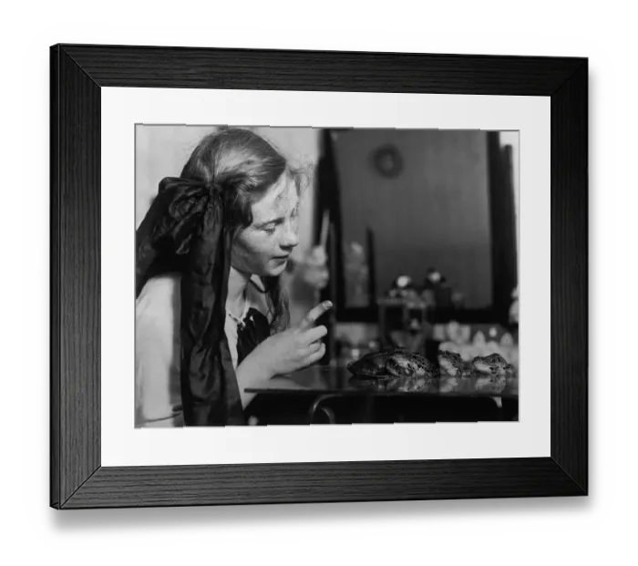 Framed Print : Teenage girl (13-15) looking at frogs Framed Print : Teenage girl (13-15) looking at frogs