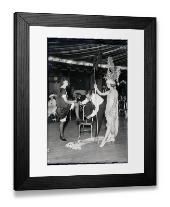 Framed Print : Woman In Costume, Man Measures Other's Leg Framed Print : Woman In Costume, Man Measures Other's Leg