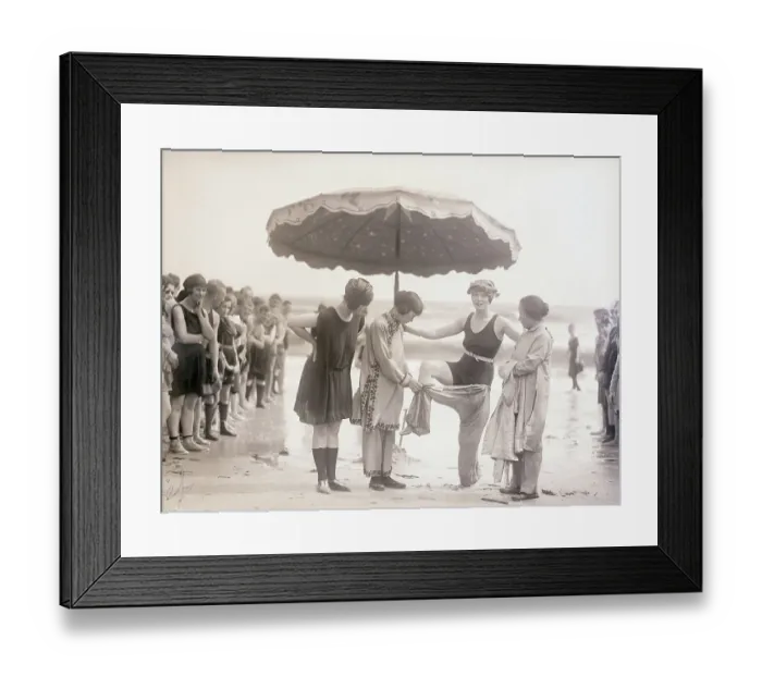 Framed Print : Vintage photograph showing young woman undressing on beach Framed Print : Vintage photograph showing young woman undressing on beach