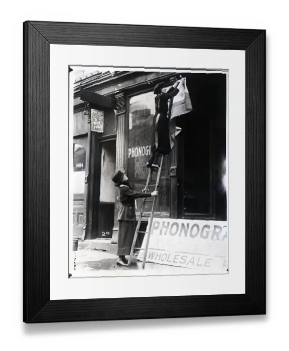 Framed Print : Woman on Ladder Fixes Women's Party Sign Framed Print : Woman on Ladder Fixes Women's Party Sign