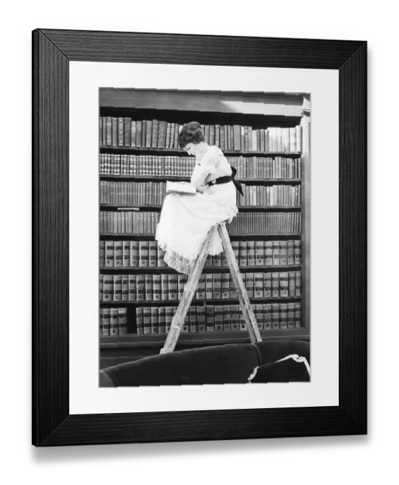 Framed Print : Woman Reading on Top of Ladder Framed Print : Woman Reading on Top of Ladder