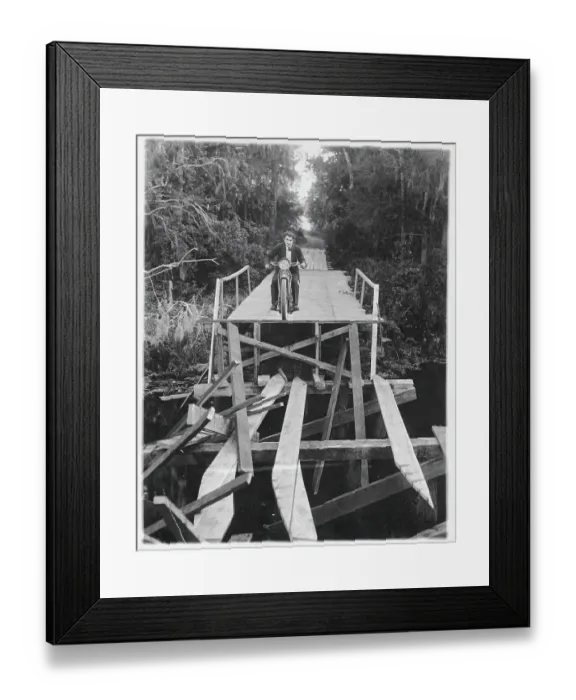 Framed Print : Man Crossing Bridge on Motorcycle Framed Print : Man Crossing Bridge on Motorcycle