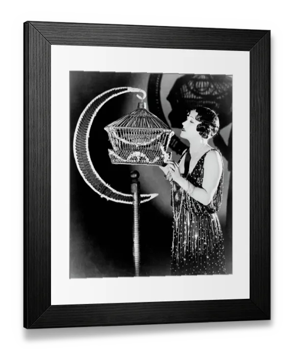 Framed Print : Actress Gloria Swanson Examining a Bird Cage
