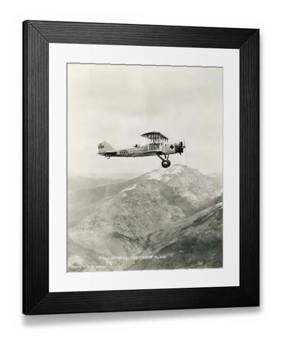 Framed Print : Mail Biplane Flying over Mountains Framed Print : Mail Biplane Flying over Mountains