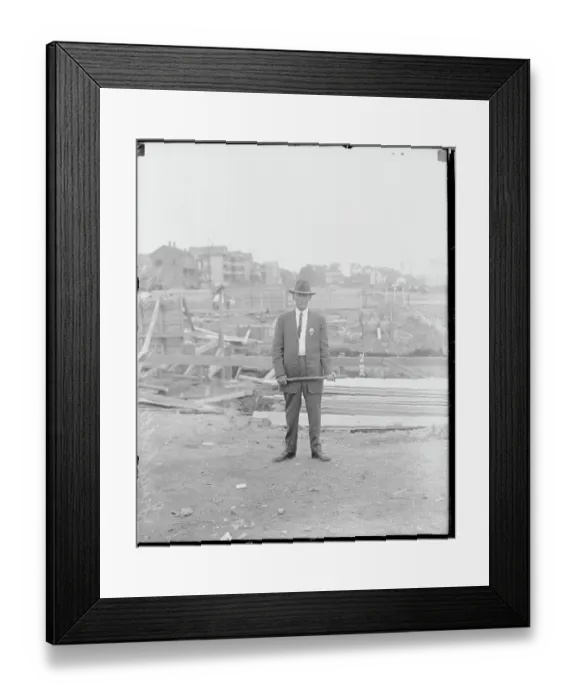 Framed Print : Man with Club Guarding Factory Framed Print : Man with Club Guarding Factory