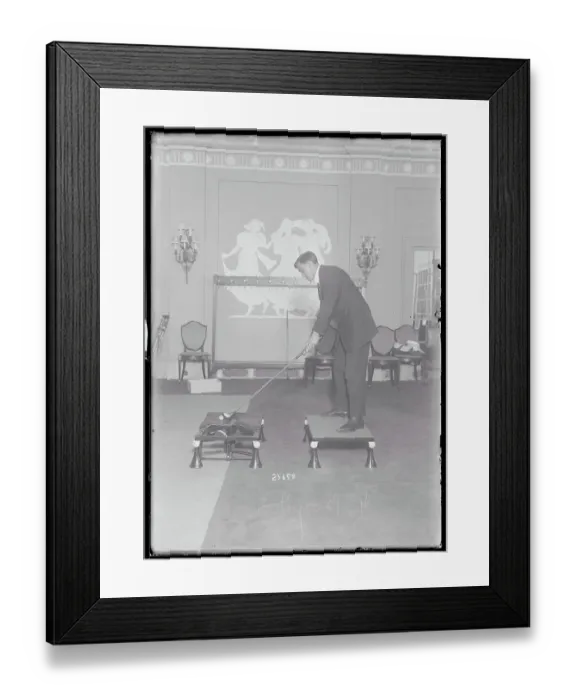 Framed Print : Man Practicing His Golf Skills Indoors Framed Print : Man Practicing His Golf Skills Indoors