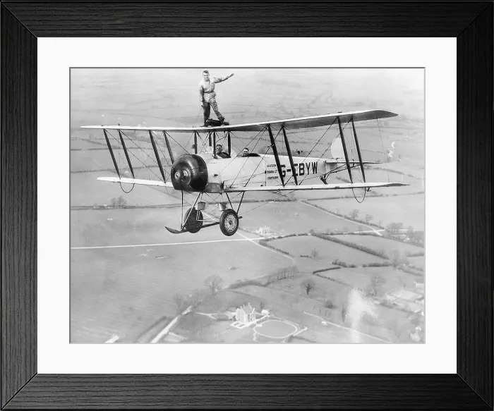 Framed Print : Stunt Flyer on Top of Plane in Midair Framed Print : Stunt Flyer on Top of Plane in Midair