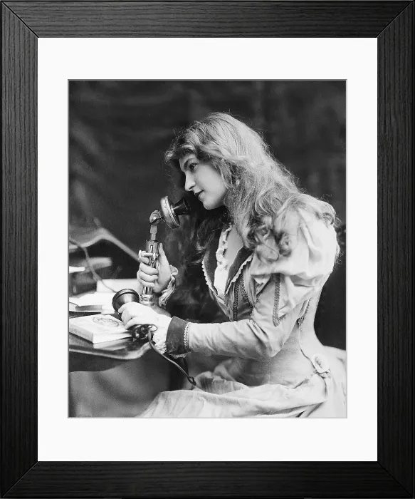 Framed Print : Young Woman Speaking into Telephone Framed Print : Young Woman Speaking into Telephone