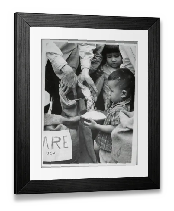 Framed Print : Small Child Receiving Food Rations in Saigon Framed Print : Small Child Receiving Food Rations in Saigon
