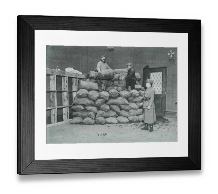 Framed Print : Men Unloading Bags of Socks