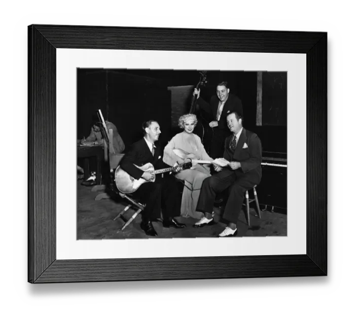 Framed Print : Mae West Sitting with Guitar and Musicians Framed Print : Mae West Sitting with Guitar and Musicians