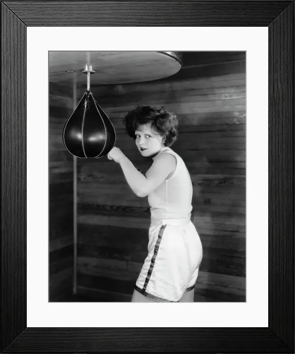 Framed Print : Clara Bow Posing with Punching Bag in Gym Shorts Framed Print : Clara Bow Posing with Punching Bag in Gym Shorts