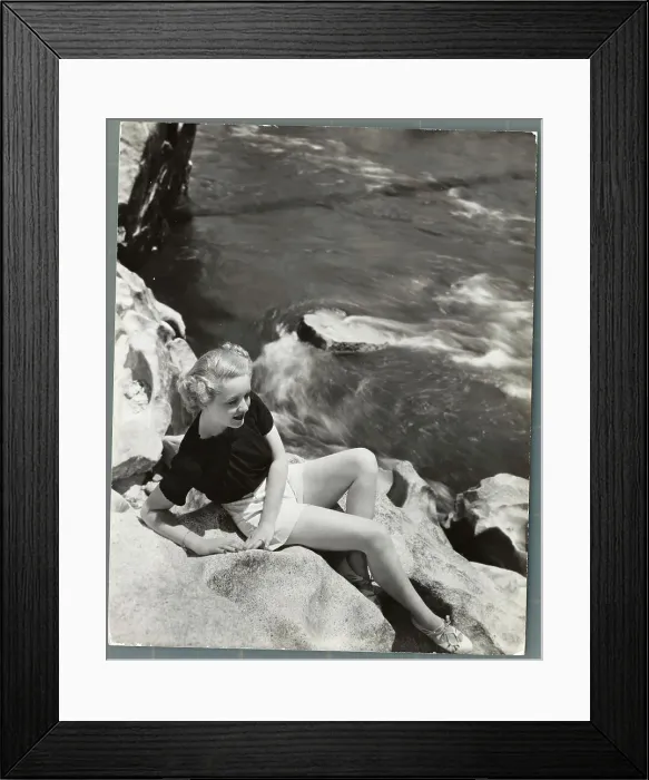 Framed Print : Actress Bette Davis Sitting on Rocks Above Water