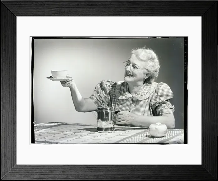 Framed Print : Elderly Woman Serving Coffee Framed Print : Elderly Woman Serving Coffee