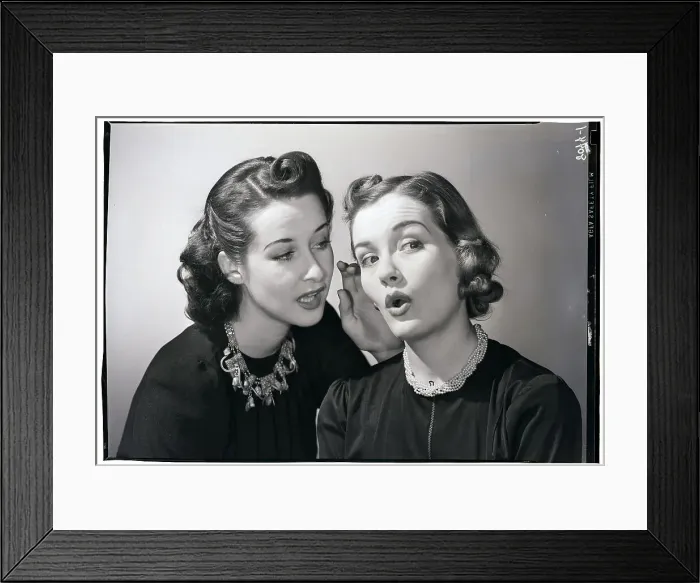Framed Print : Woman Whispering in Friend's Ear Framed Print : Woman Whispering in Friend's Ear