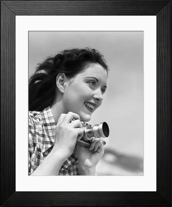 Framed Print : Woman Smiles as She Holds Camera Framed Print : Woman Smiles as She Holds Camera