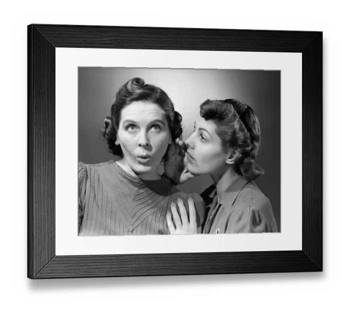 Framed Print : Woman Whispering in Friend's Ear Framed Print : Woman Whispering in Friend's Ear