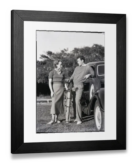 Framed Print : Couple of Young Golfers Standing by Car Framed Print : Couple of Young Golfers Standing by Car