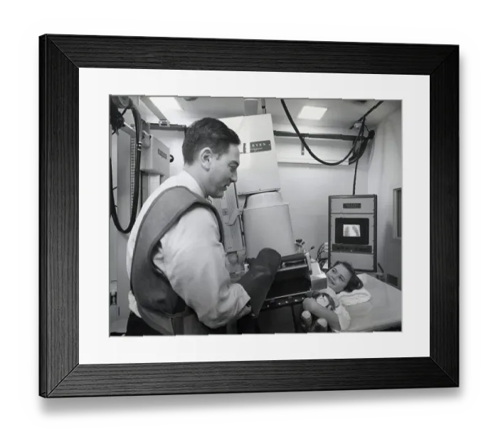 Framed Print : Technician Setting X-Ray Up For Girl Framed Print : Technician Setting X-Ray Up For Girl