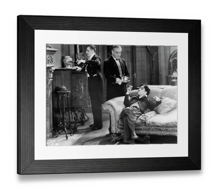 Framed Print : Charlie Chaplin Reclining On A Sofa