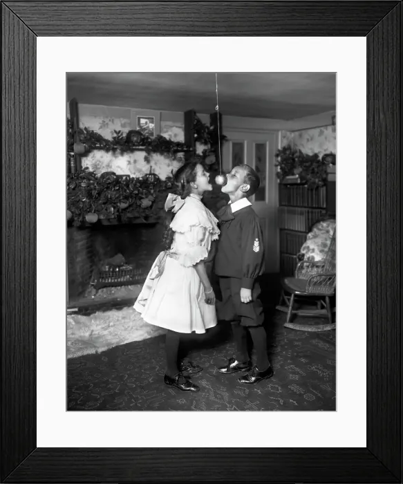 Framed Print : Children Trying to Bite Apple on a String