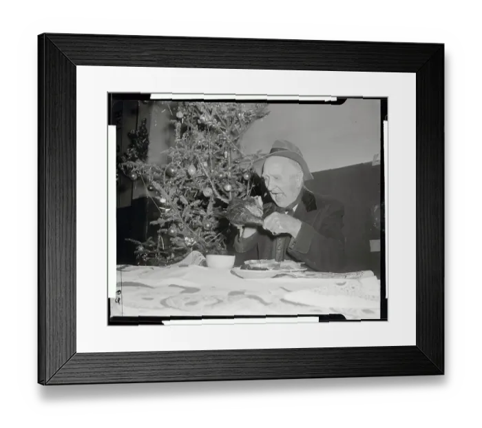 Framed Print : Elderly Man Eating Large Piece of Poultry at Table Framed Print : Elderly Man Eating Large Piece of Poultry at Table