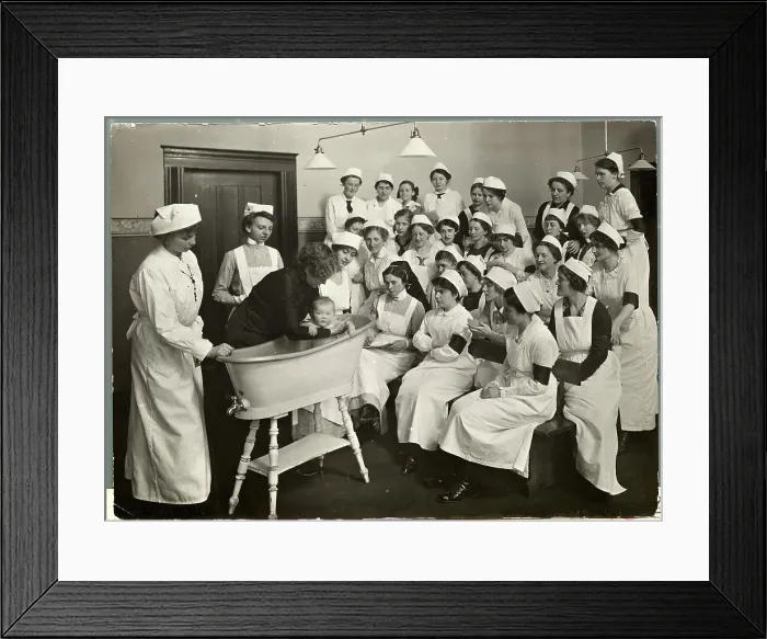 Framed Print : Woman Instructing How to Bathe Babies Framed Print : Woman Instructing How to Bathe Babies