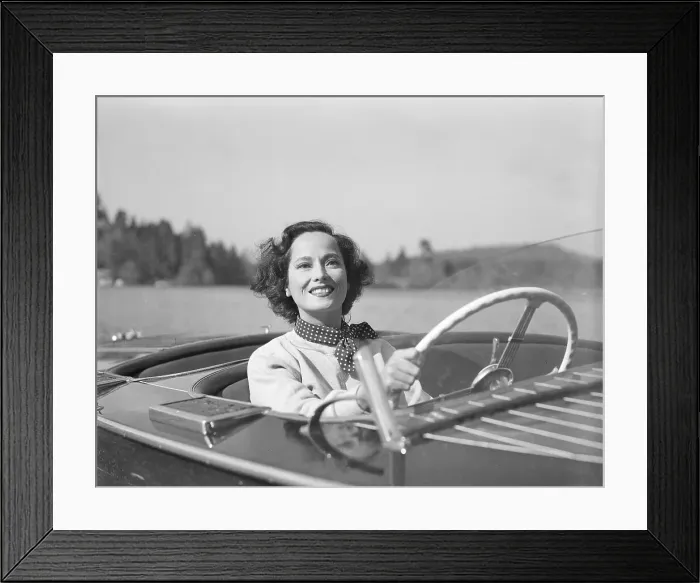 Framed Print : Merle Oberon Driving a Motorboat