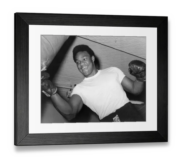 Framed Print : George Foreman Strikes Punching Bag Framed Print : George Foreman Strikes Punching Bag