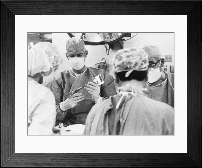 Framed Print : Surgeon Checking A Surgical Stapler Framed Print : Surgeon Checking A Surgical Stapler