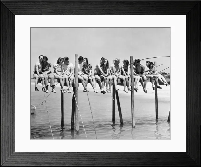 Framed Print : Couples sitting on pier Framed Print : Couples sitting on pier