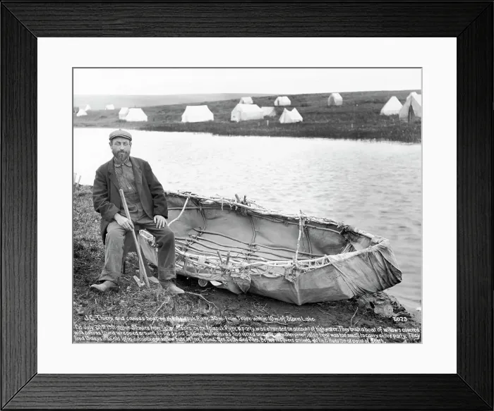 Framed Print : Man Sitting Next To Canvas Canoe Framed Print : Man Sitting Next To Canvas Canoe