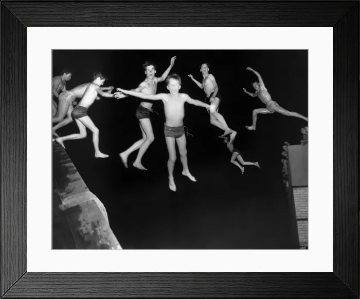 Framed Print : Multiple image of pre--teen boy jumping into water Framed Print : Multiple image of pre--teen boy jumping into water