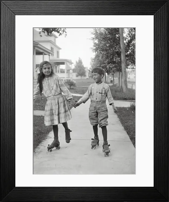 Framed Print : Girl (10-12) and boy (8-9) roller skating Framed Print : Girl (10-12) and boy (8-9) roller skating