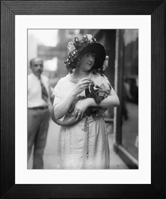 Framed Print : Vintage photograph of pre-teen girl (10-12) carrying monkey Framed Print : Vintage photograph of pre-teen girl (10-12) carrying monkey