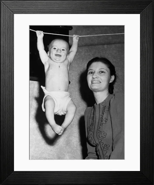 Framed Print : Mother with baby boy (6-11 months) hanging on rope Framed Print : Mother with baby boy (6-11 months) hanging on rope